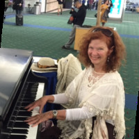 Nancy playing piano at Portland International Airport